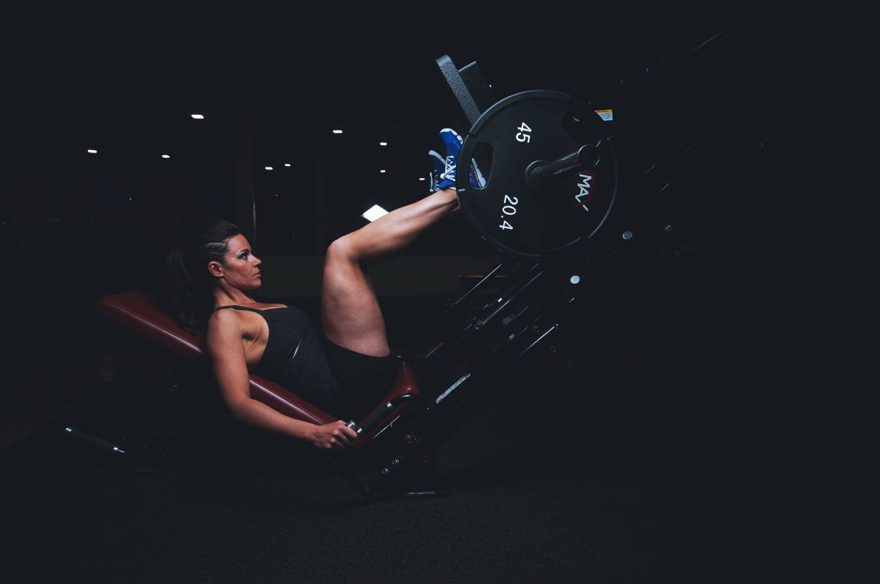 services-img A woman engages in an intense leg press workout at the gym, showcasing strength and fitness.